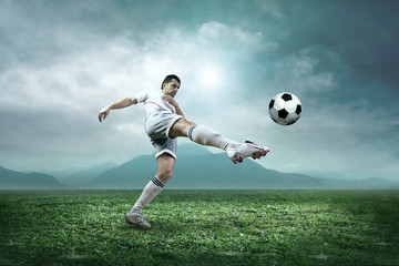 Soccer player with ball in action outdoors.