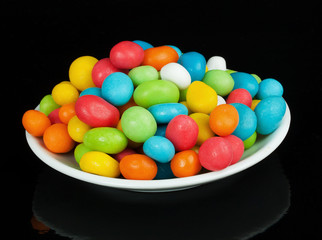 colored candies in white saucer
