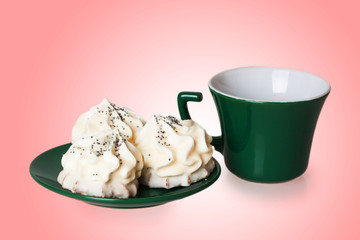 cakes on a green saucer with a cup