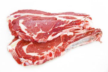 Pieces of crude meat, beef steak on white. Isolated