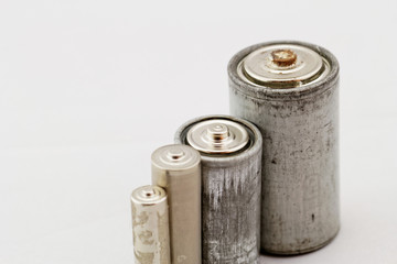 Old batteries on white background