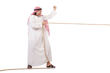 Arab in tug of war concept on white