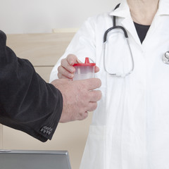 Doctor passes urine cups to patients