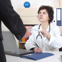 Doctor writes prescription for patients