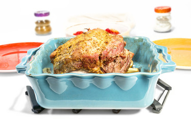 baked meat with spices and plates on the table