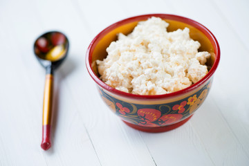 Cottage cheese served in wooden khokhloma tableware