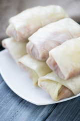 Close-up of uncooked cabbage leaves stuffed with meat filling