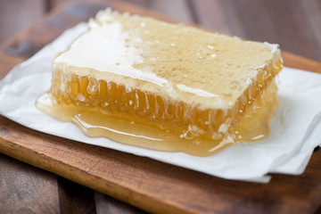Close-up of a honeycomb over rustic wooden background