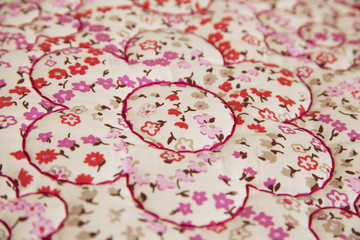Fabric with red floral design ornaments