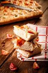Focaccia with tomato and green olives. Retouching in retro style