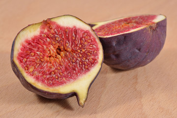 Fresh figs halved on wooden board