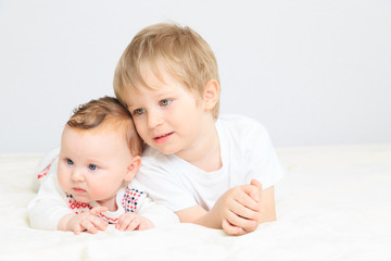 portrait of little boy with newborn sister