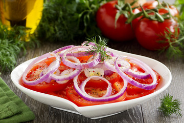 Salad of red tomatoes and onions.