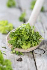 Parsley on a wooden spoon