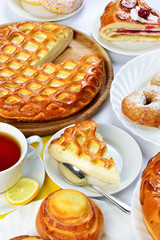 still life of setout table with baking pies, donuts and tee cup