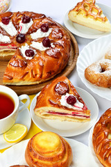 still life of setout table with baking pies, donuts and tee cup
