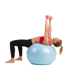 Fototapeta na wymiar Female Exercise On Fitness Ball With Hand Weights