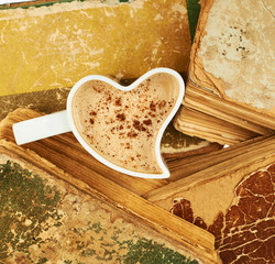 Cup of coffee over the old books