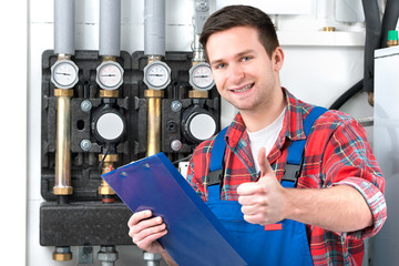 Technician servicing heating boiler