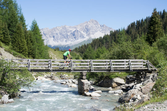 Mountain biker crossing bridge