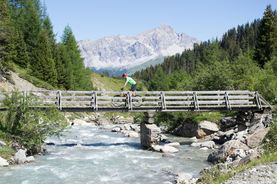 Mountain biker crossing bridge