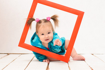Baby girl holding hands red frame