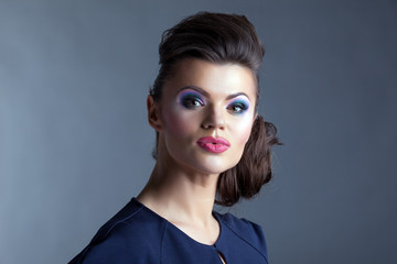 Cute model with evening make-up posing at camera