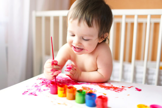 18 months baby with paints