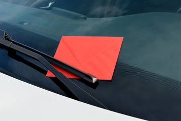 letter under a windshield wiper