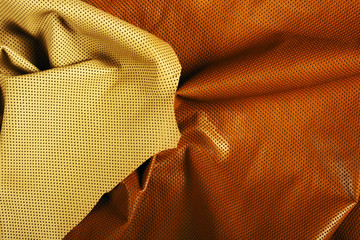 Yellow and brown perforated leather background