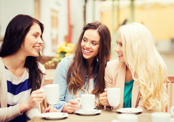beautiful girls drinking coffee in cafe