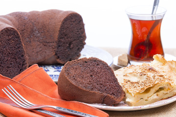 Freshly baked borek and chocolate cake at a party