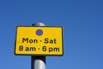 Yellow no parking sign between Monday and Saturday 8am - 6pm