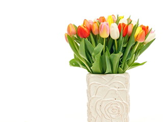 Bouquet of beautiful tulips at porcelain vase