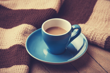 blue cup of the coffee and vintage scarf.