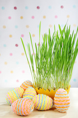 Easter eggs and oat grass on speckled background