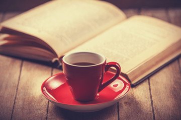 red cup of the coffee and vintage book.