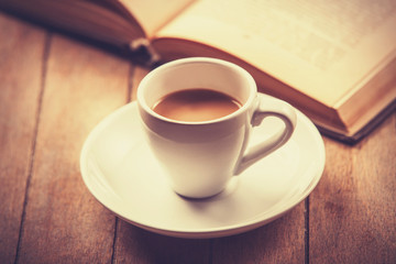 white cup of the coffee and vintage book.