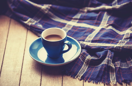 blue cup of the coffee and vintage scarf.