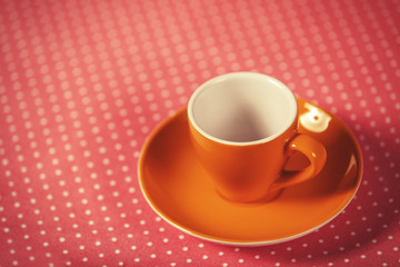 Cup of a coffe on polka dot cover.