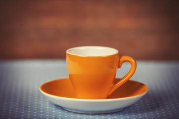 Cup of a coffe on polka dot cover.