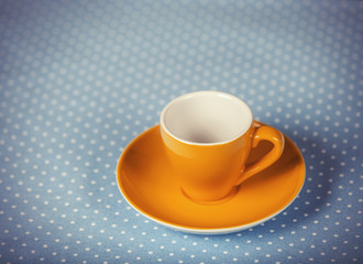 Cup of a coffe on polka dot cover.