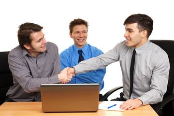 Young business people shaking hands, finishing up a meeting