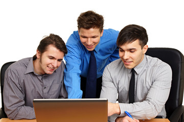 Young business people at work discuss with the computer