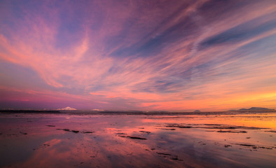 Fototapeta na wymiar Incredible sky and reflection over Mount Baker at sunset from Boundary Bay, British Columbia, Canada