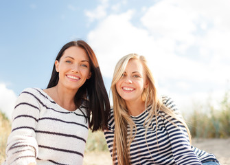 smiling girlfriends having fun on the beach