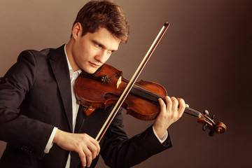 Man violinist playing violin. Classical music art © Voyagerix