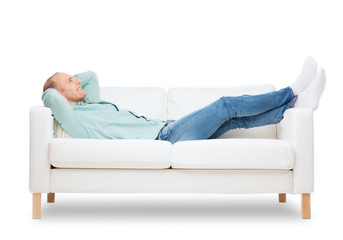 smiling man lying on sofa