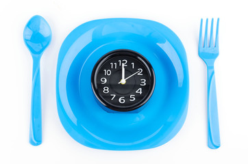 Naklejka premium Concept photo , dish fork spoon clock isolated on white backgrou