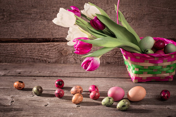 flowers and easter eggs  on wooden background